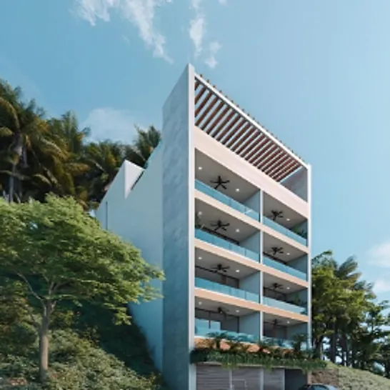 Edificio blanco de cinco niveles con pérgola en la azotea, rodeado de selva